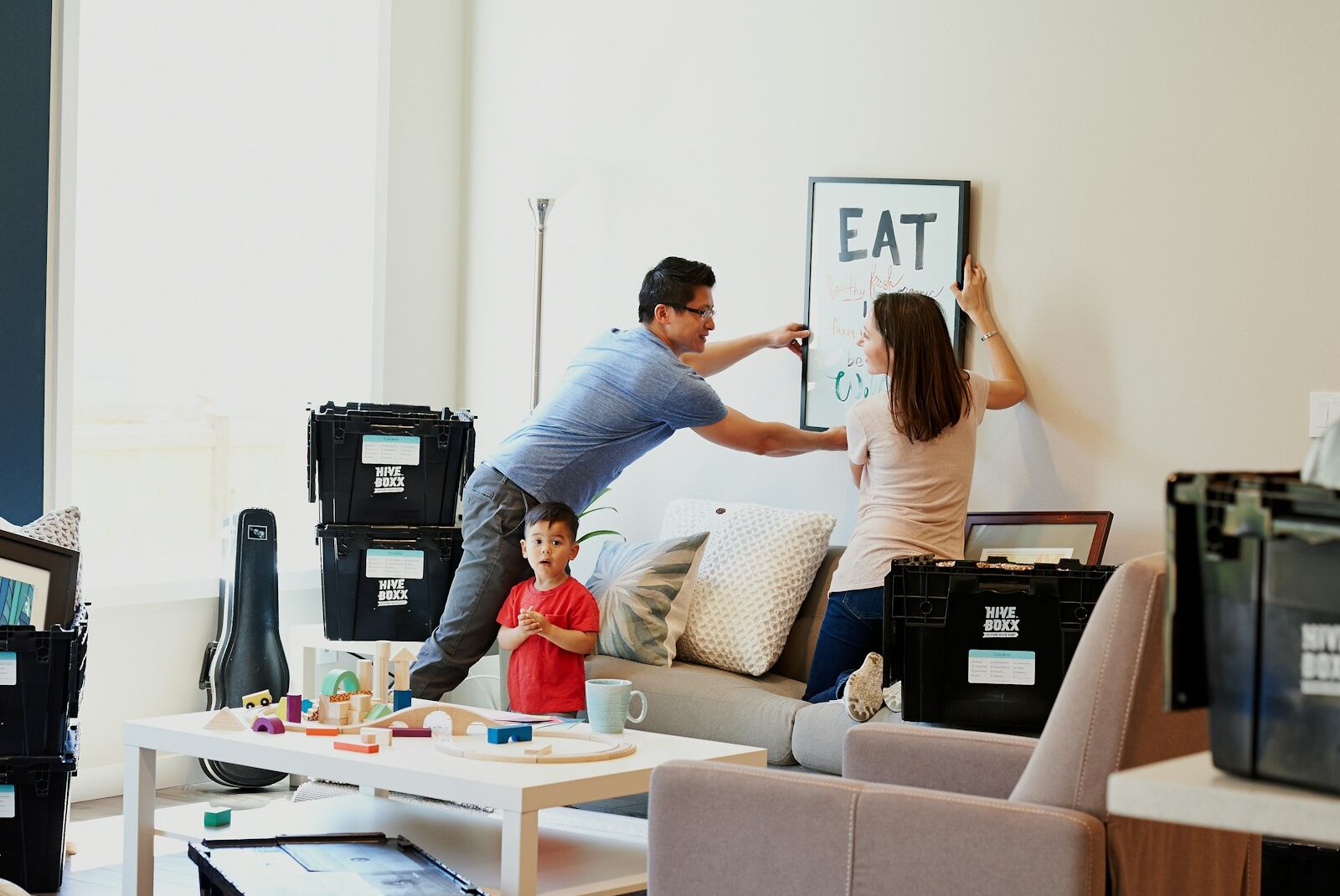 man and woman hanging artwork on the wall dealing with life transitions