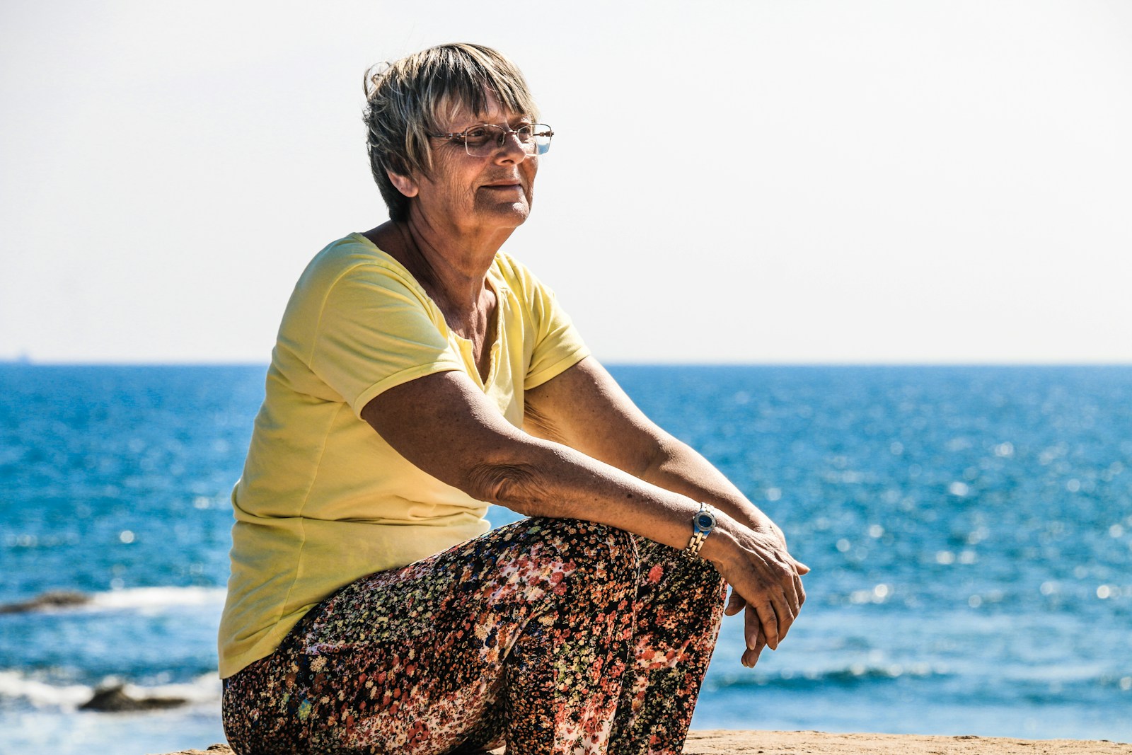 woman sitting on seashore representative of gray divorce