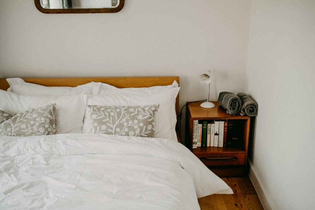 Cozy guest bedroom with a neatly made bed and bedside table.